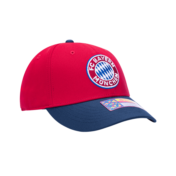 Side view of the Bayern Munich Core Adjustable hat with mid constructured crown, cruved peak brim, and slider buckle closure, in Red/Blue.